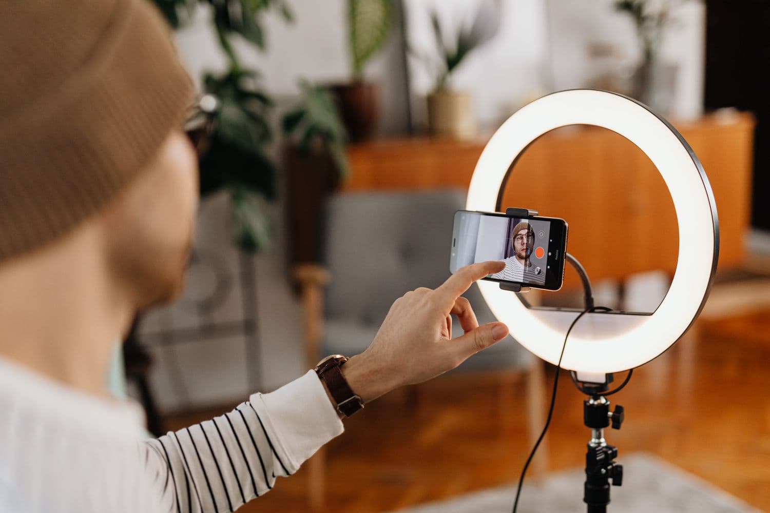 Content being filmed on a phone with ring light